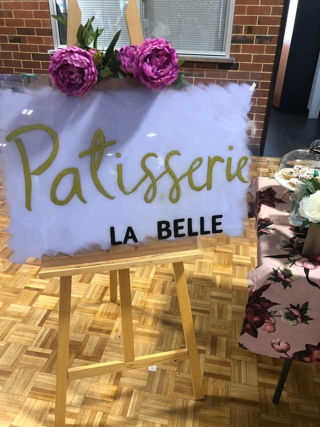 Patisserie La Belle hand-lettered sign with fresh peonies at a Perth pop-up market