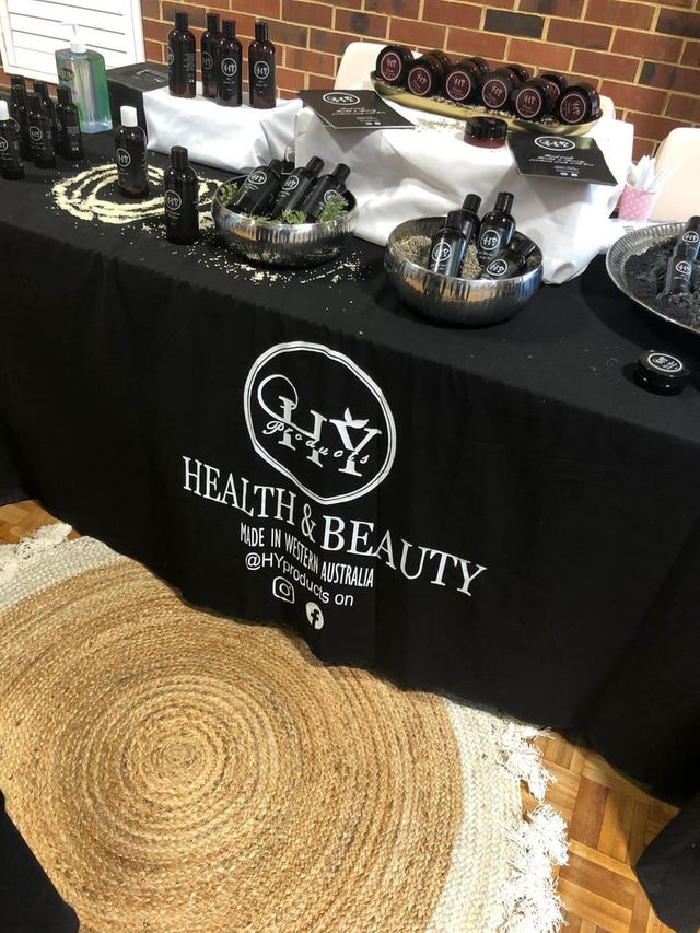 Artisan skincare products displayed in gold-trimmed bowls at a Perth pop-up market stall