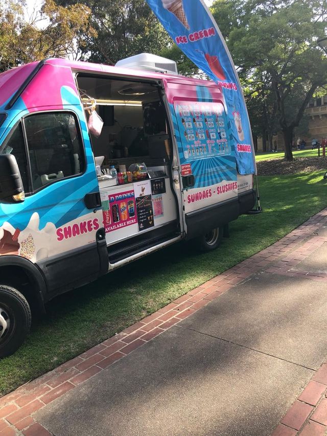Retro pink and turquoise ice cream van serving treats at an outdoor Urban Pop Ups market