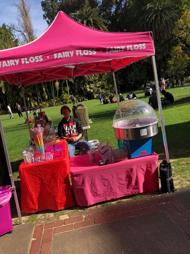 Fairy floss stall under a pink marquee at an Urban Pop Ups market in a Perth park